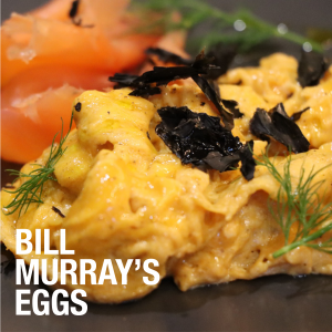 Scrambled eggs with smoked salmon and white text in bottom left corner "Bill Murray's Eggs"