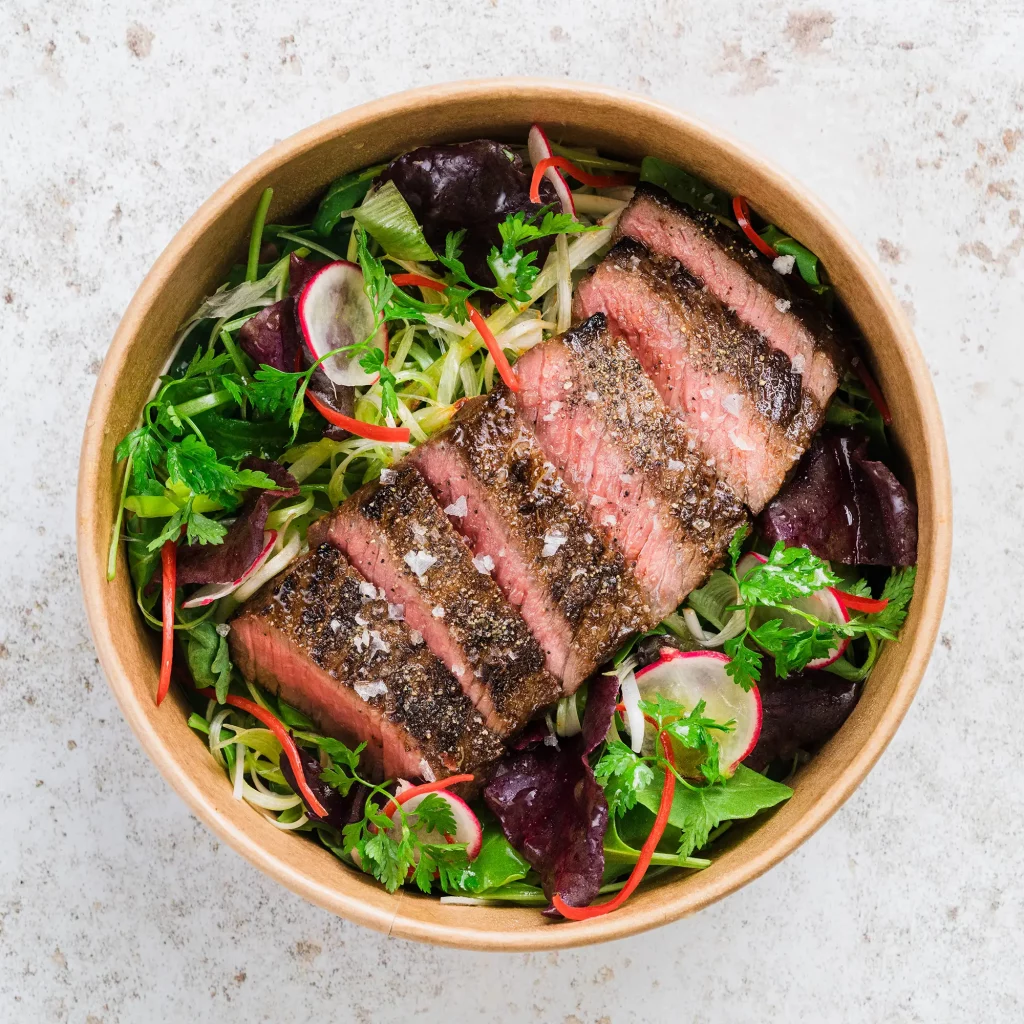 Steak and salad, photographed from above