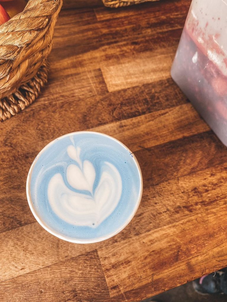 A blue cup of coffee.
