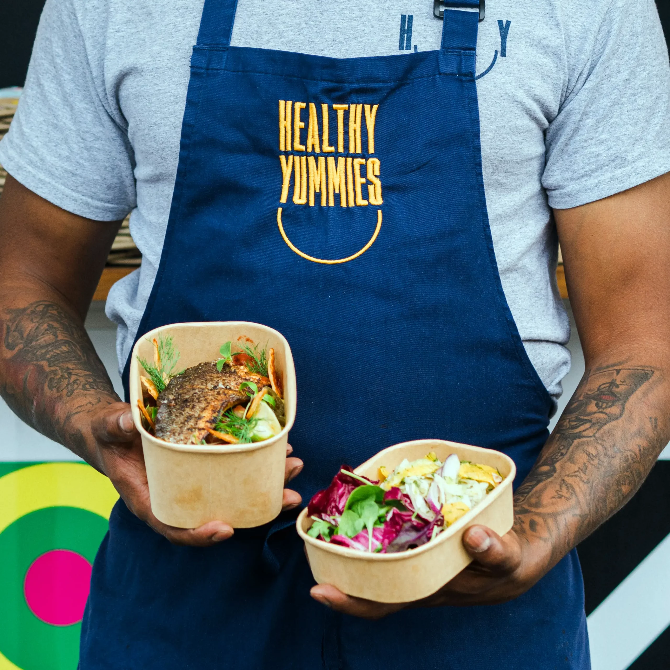 A Yummies member of staff serving hot-boxed meals on a London film set.